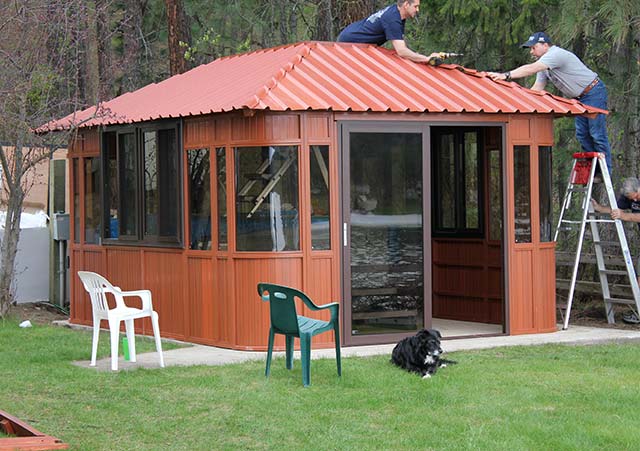 men installing a gazebo roof